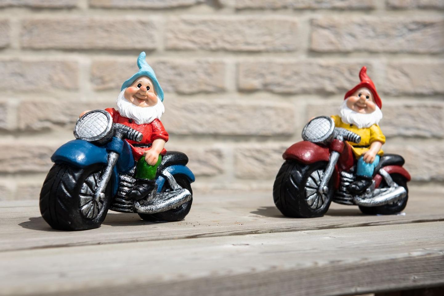 Two garden gnomes on their motorcycle on a wooden bench Garden ID